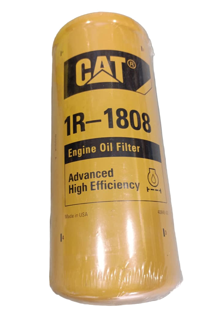 Yellow engine oil filter with 'Cat' branding on a concrete surface