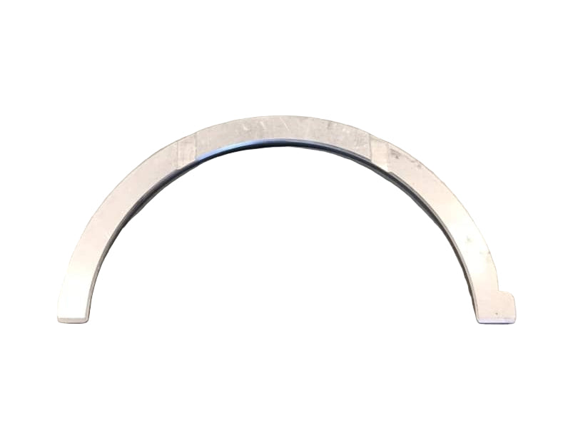 Metallic U-shaped ring on a gray surface