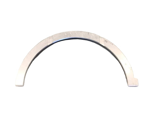 Metallic U-shaped ring on a gray surface